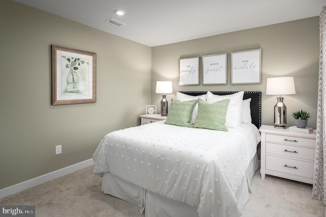 bedroom with visible vents, baseboards, and light colored carpet