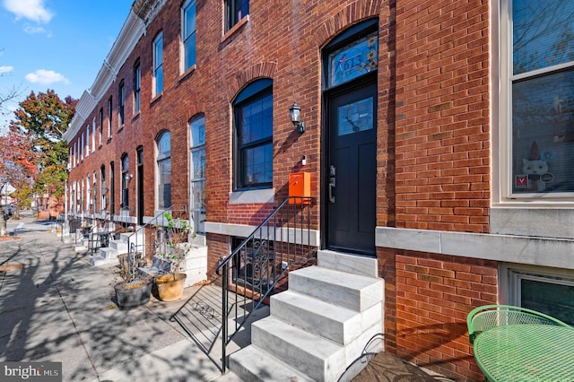 property entrance with brick siding