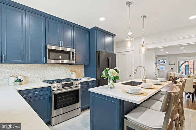 kitchen featuring decorative backsplash, appliances with stainless steel finishes, light countertops, and blue cabinets