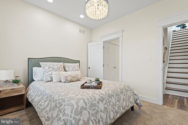 bedroom featuring visible vents, a notable chandelier, recessed lighting, carpet flooring, and baseboards