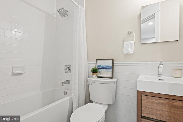 full bathroom with vanity, shower / tub combo, wainscoting, tile walls, and toilet