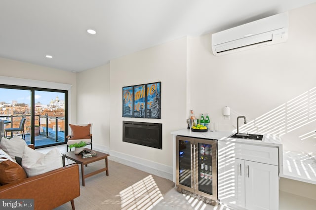 living area featuring a wall mounted AC, a glass covered fireplace, wine cooler, wet bar, and baseboards