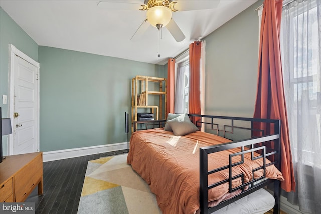 bedroom with wood finished floors and baseboards