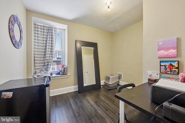 office space with dark wood-style floors, visible vents, and baseboards