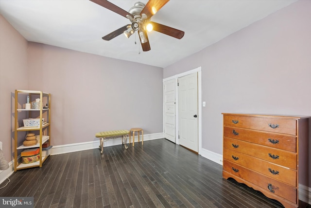 interior space featuring wood finished floors, baseboards, and ceiling fan