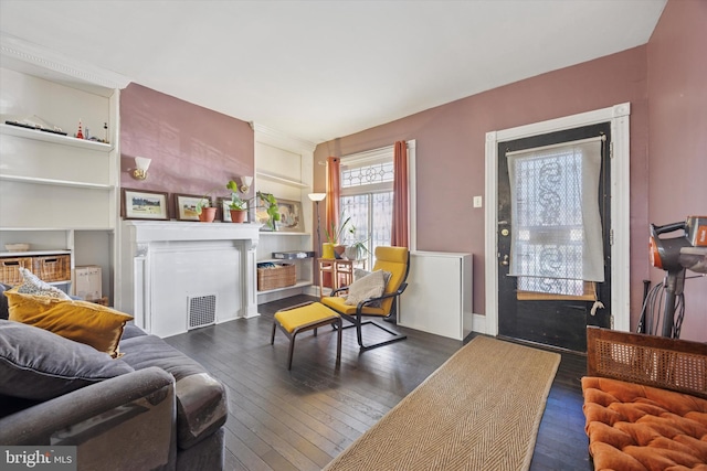 living room with visible vents and hardwood / wood-style floors