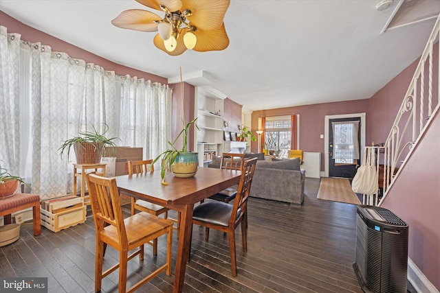 dining room with ceiling fan, baseboards, heating unit, and wood finished floors