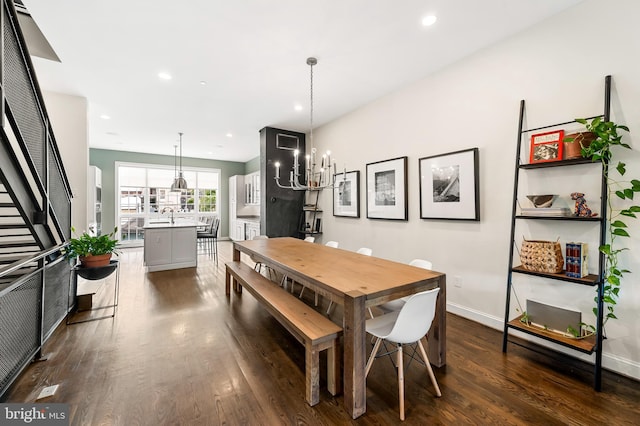 dining area featuring dark wood-style floors, a notable chandelier, recessed lighting, and baseboards