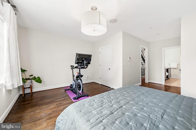 bedroom featuring baseboards and wood finished floors