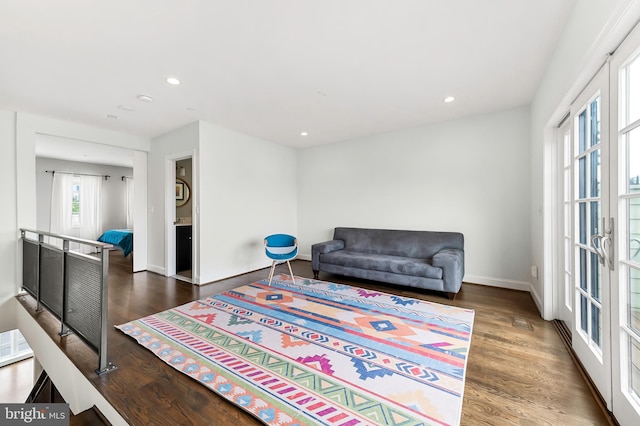 sitting room with recessed lighting, baseboards, an upstairs landing, and wood finished floors