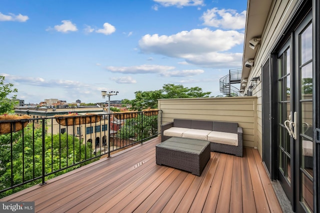 wooden terrace with an outdoor hangout area