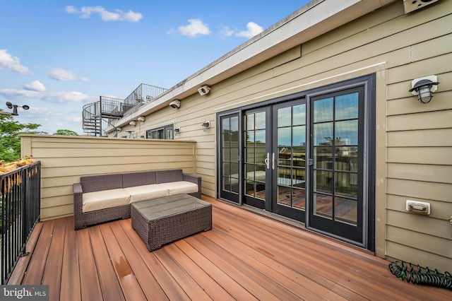 wooden terrace with an outdoor living space