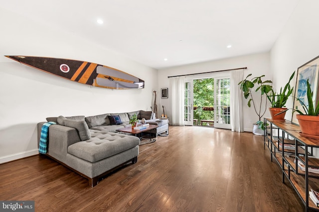 living room with recessed lighting, baseboards, and wood finished floors