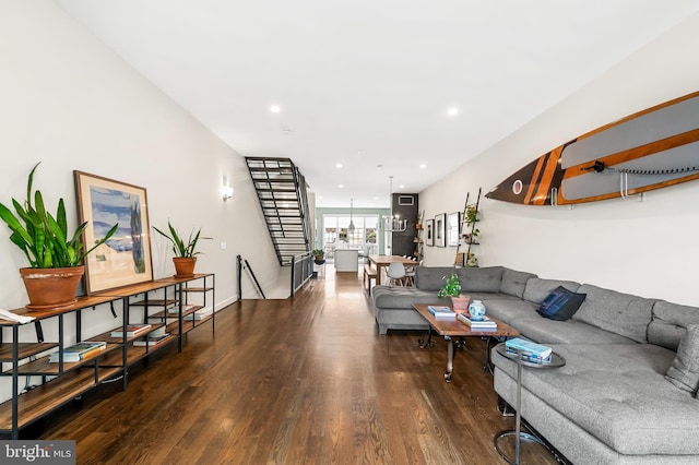 living room with stairs, recessed lighting, wood finished floors, and baseboards