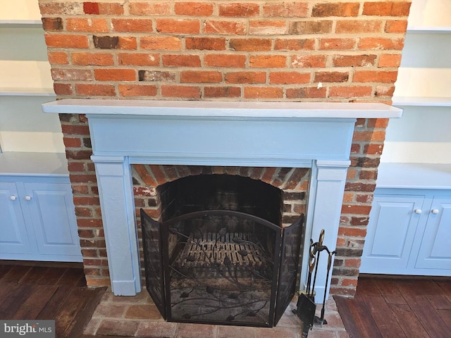 interior details with wood finished floors and a fireplace