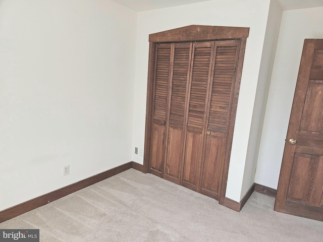 unfurnished bedroom featuring baseboards and carpet floors