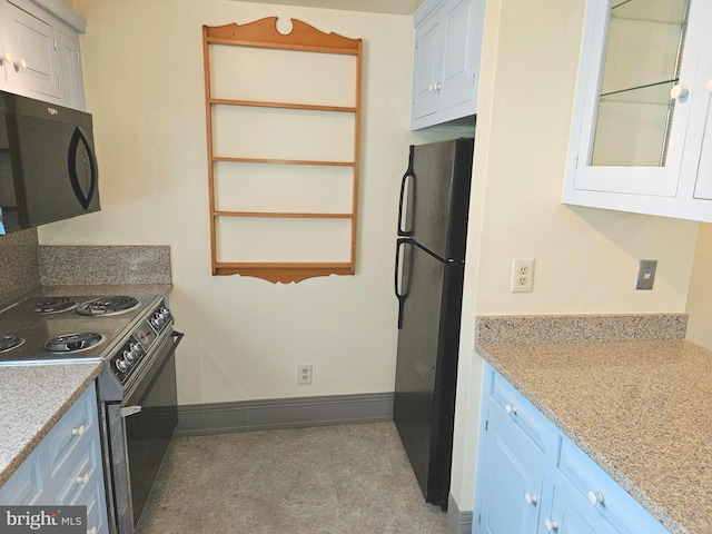 kitchen featuring blue cabinetry, glass insert cabinets, baseboards, and black appliances