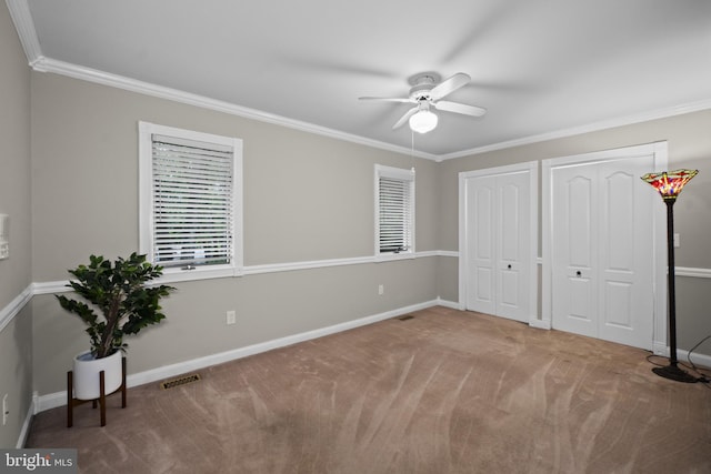 8359 Elm Rd, Millersville, MD 21108 - unfurnished bedroom featuring multiple closets, ornamental molding, carpet floors, baseboards, and ceiling fan