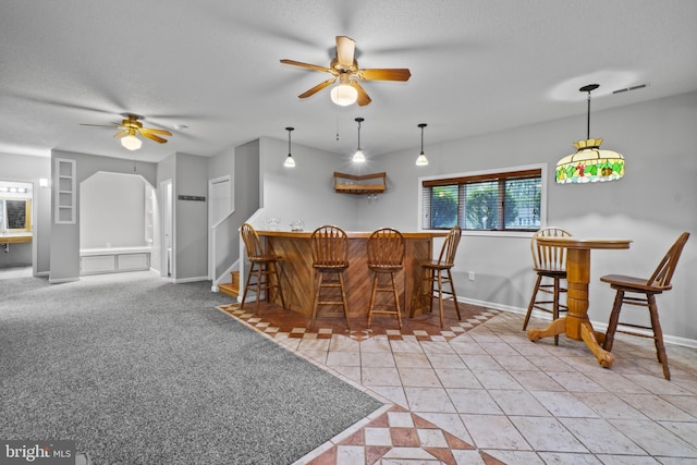 8359 Elm Rd, Millersville, MD 21108 - dining space with ceiling fan, a dry bar, baseboards, a textured ceiling, and stairs