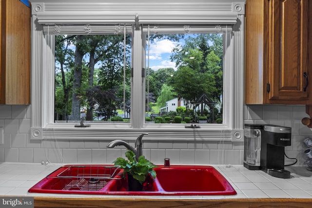 8359 Elm Rd, Millersville, MD 21108 - kitchen view of tile counters, a sink, and tasteful backsplash