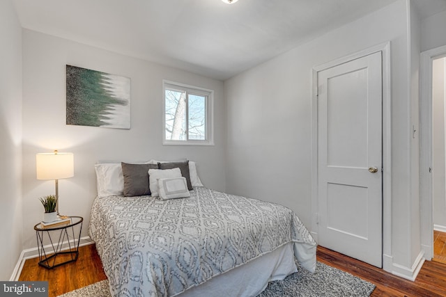 bedroom featuring baseboards and wood finished floors