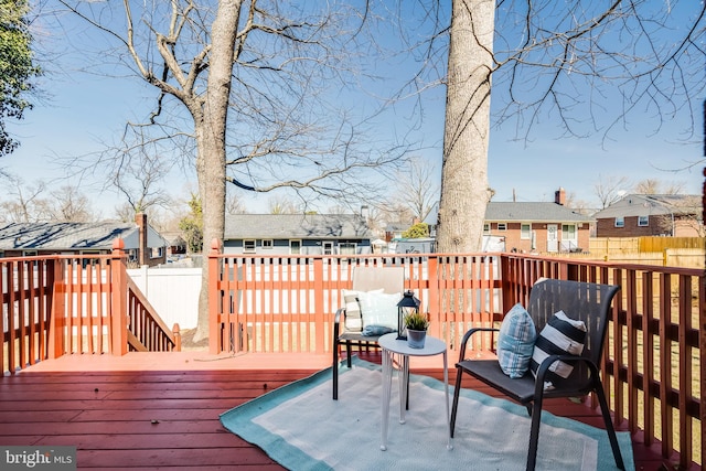 deck featuring fence and a residential view