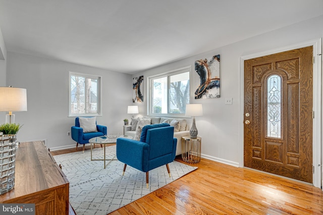 living area with light wood-style floors and baseboards