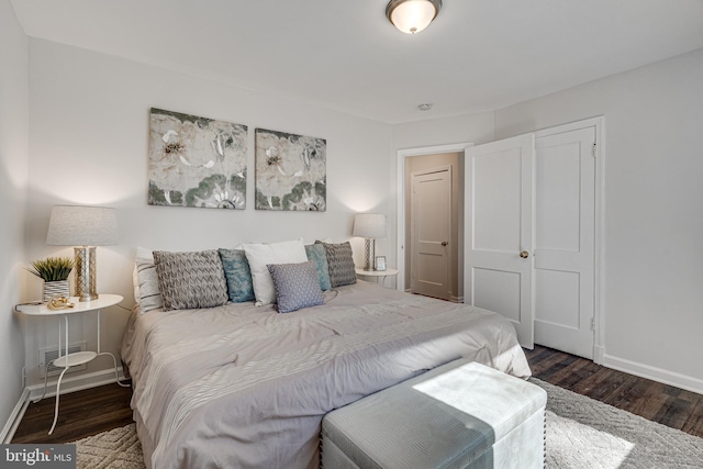 bedroom featuring visible vents, wood finished floors, and baseboards