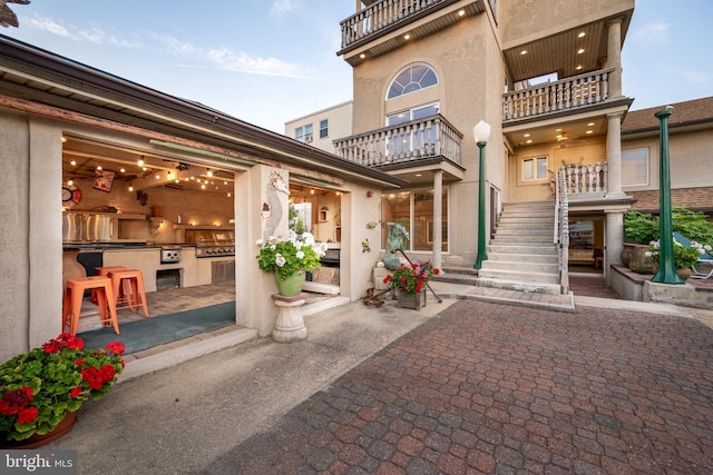 exterior space featuring stairway and stucco siding