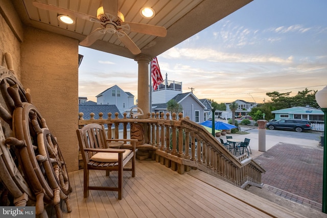 wooden terrace featuring a residential view and ceiling fan