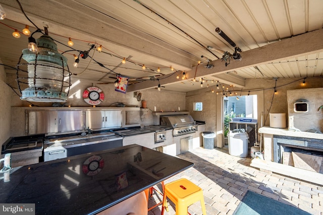 kitchen with beam ceiling and brick floor