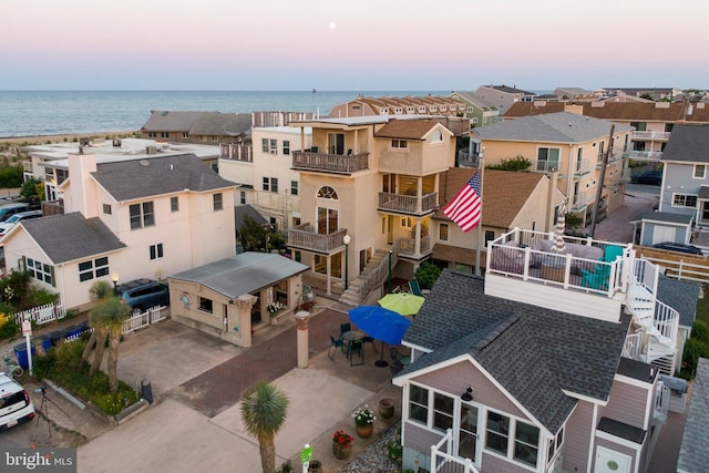 drone / aerial view featuring a residential view and a water view