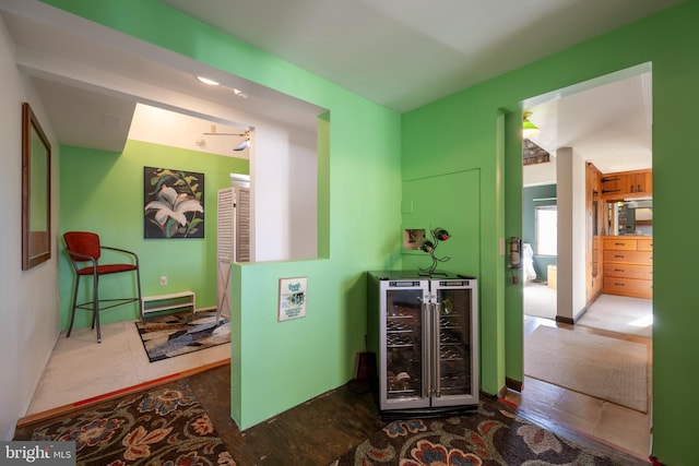 corridor with wine cooler and a baseboard radiator