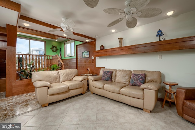 living area featuring light tile patterned floors and a ceiling fan