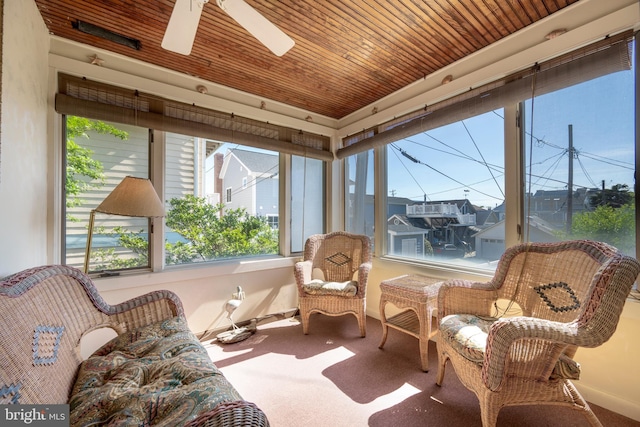 sunroom / solarium with wooden ceiling and a ceiling fan