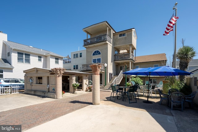 view of home's community featuring fence and a patio area