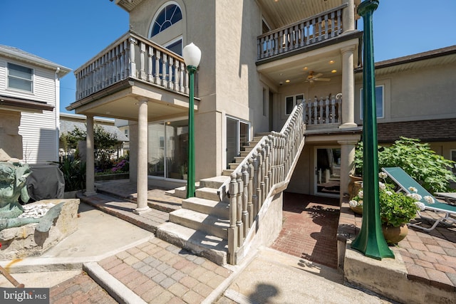 exterior space featuring stairway and a ceiling fan