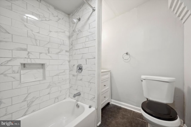 bathroom with baseboards, bathing tub / shower combination, vanity, and toilet