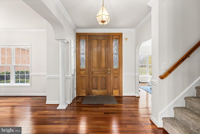 foyer with visible vents, arched walkways, and wood-type flooring