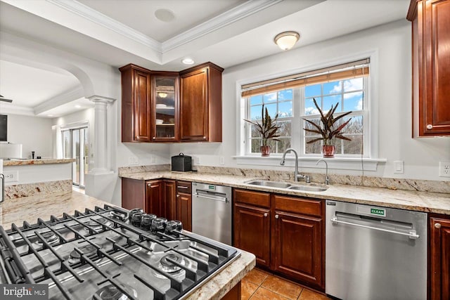 kitchen with a sink, decorative columns, dishwasher, and crown molding