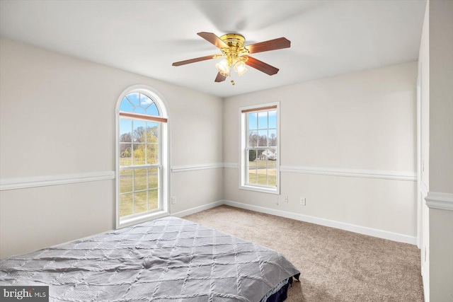 bedroom with multiple windows, carpet, baseboards, and ceiling fan