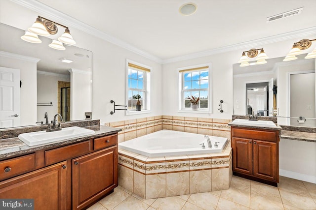 bathroom with a garden tub, two vanities, visible vents, and a sink