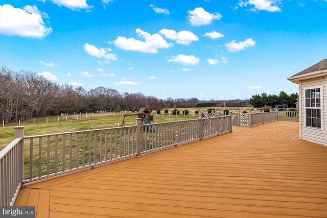 deck with a lawn and a playground