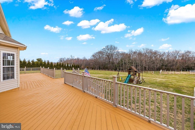 wooden deck featuring a playground and a yard