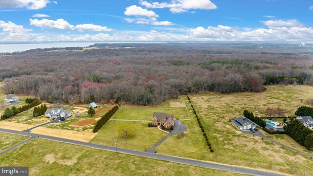 aerial view with a forest view and a water view