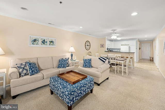 living room with recessed lighting, light carpet, ceiling fan, and crown molding