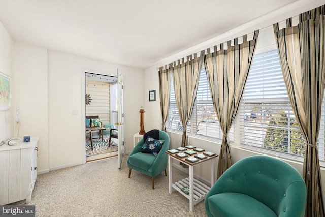 sitting room with light colored carpet and baseboards