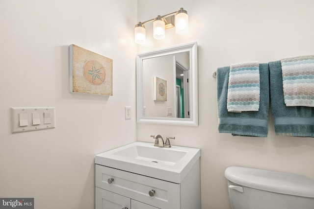 bathroom with toilet and vanity