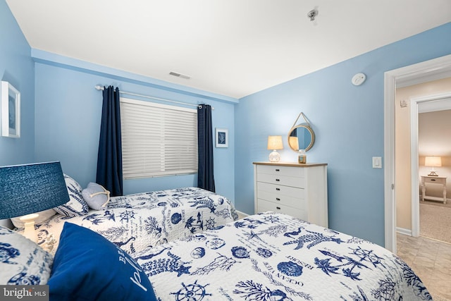 bedroom with baseboards and visible vents