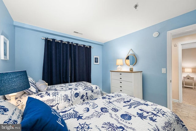 bedroom featuring visible vents and baseboards